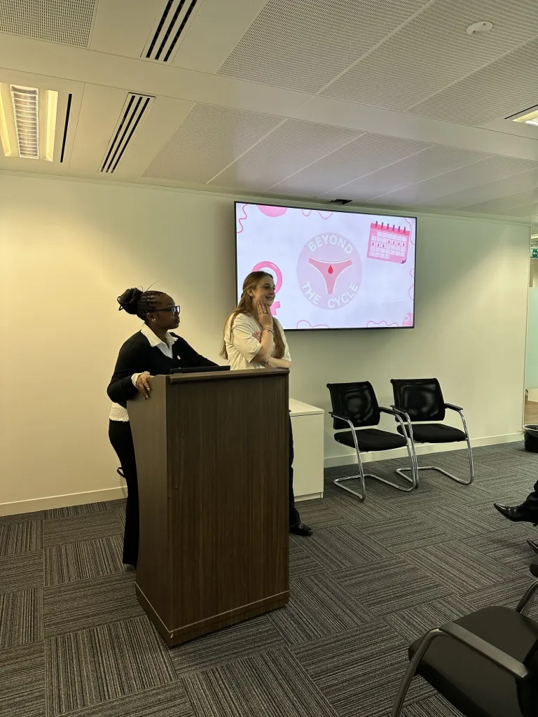 Beyond the Cycle team giving a talk from a podium at a corporate event